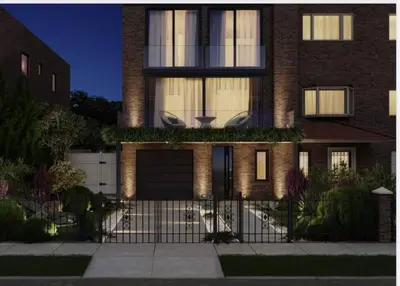 a house with a fence in front of it at 2 Story Villa in Upper Ditmars Astoria Queens in Steinway