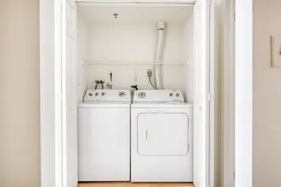 a white laundry room with a washer and dryer at Jersey City 2br w wd gym elevator nr path NYC-672 in New York