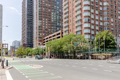 an empty street in a city with tall buildings at Jersey City 2br w wd gym elevator nr path NYC-672 in New York