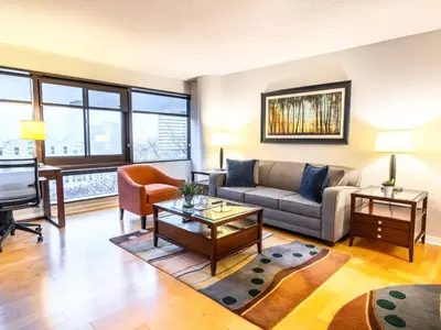 a living room with a couch and a table at Centrally Located Apt Downtown in Stamford