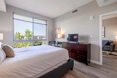 a bedroom with a large bed and a large window at Modern Apt with Luxury Amenities in Stamford