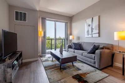 a living room with a couch and a tv at Modern Apt with Luxury Amenities in Stamford