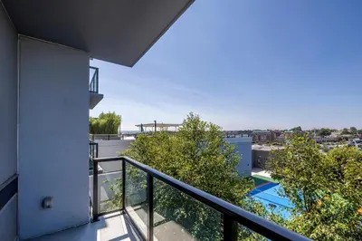 an apartment balcony with a view of a pool at Modern Apt with Luxury Amenities in Stamford