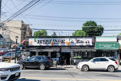 a street with cars parked in front of a store at Harty's Terrace 9 Kimball Avenue in Yonkers