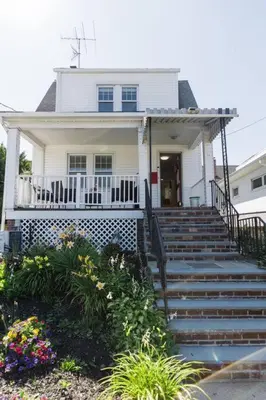 a white house with stairs in front of it at Harty's Terrace 9 Kimball Avenue in Yonkers