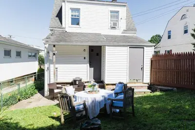a table in the backyard of a white house at Harty's Terrace 9 Kimball Avenue in Yonkers