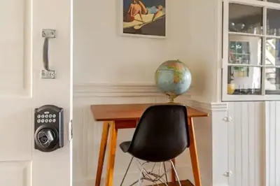 a desk with a chair and a globe on top of it at 1BR Hudson Apartment 3Min Walk To Warren St For Two in Hudson