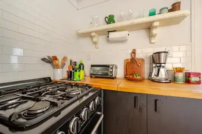 a kitchen with a stove and a counter top at 1BR Hudson Apartment 3Min Walk To Warren St For Two in Hudson