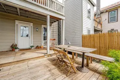 a wooden deck with a wooden table and chairs at 1BR Hudson Apartment 3Min Walk To Warren St For Two in Hudson