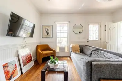 a living room with a gray couch and a table at 1BR Hudson Apartment 3Min Walk To Warren St For Two in Hudson