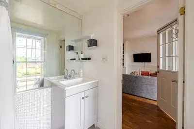 a white bathroom with a sink and a window at 1BR Hudson Apartment 3Min Walk To Warren St For Two in Hudson