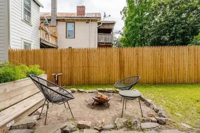 two chairs and a table in a backyard with a fence at 1BR Hudson Apartment 3Min Walk To Warren St For Two in Hudson