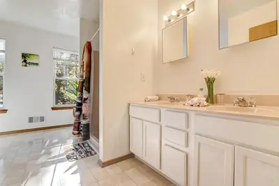 a white bathroom with a sink and a mirror at Modern Lakefront Oasis Relaxing Hot Tub Sauna Game Rooms Stunning Views! in East Stroudsburg