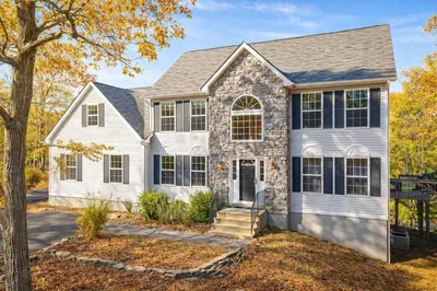 a home with a stone house at Modern Lakefront Oasis Relaxing Hot Tub Sauna Game Rooms Stunning Views! in East Stroudsburg