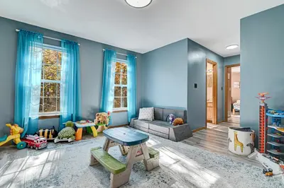 a living room with blue walls and a couch at Modern Lakefront Oasis Relaxing Hot Tub Sauna Game Rooms Stunning Views! in East Stroudsburg