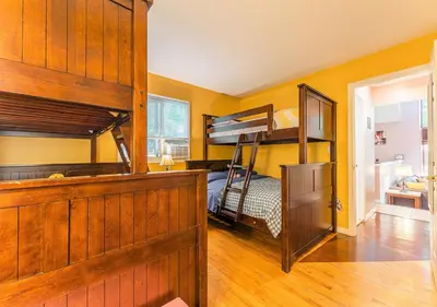 a bedroom with two bunk beds in a room at Charming Lakefront Getaway with Hot Tub & Game Room Perfect for Families! in East Stroudsburg