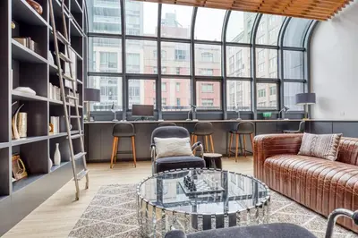 a living room with a couch and a glass table at Blueground Chelsea gym doorman nr market NYC-494 in New York