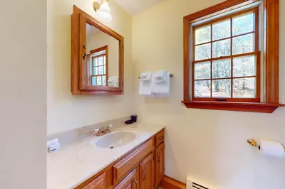 a bathroom with a sink and a mirror and a window at Green Mountain Sunrise in Dover