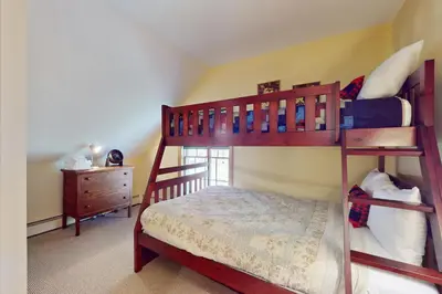 a bedroom with two bunk beds and a dresser at Green Mountain Sunrise in Dover