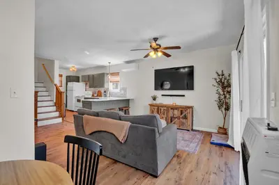 a living room with a couch and a kitchen at Lakefront, Hot Tub, Dock, Kayaks, Amazing Views in Lake Ariel
