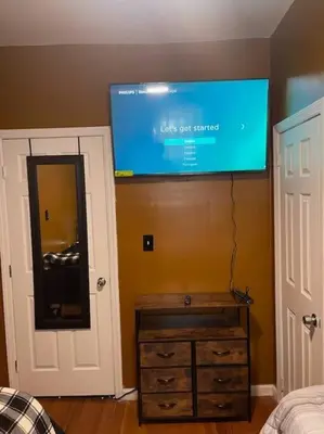 a flat screen tv on the wall of a bedroom at Large 3 BRM 2 Bath Near EWR NYC in Newark