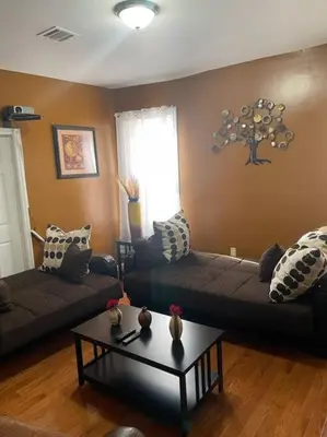 a living room with a couch and a table at Large 3 BRM 2 Bath Near EWR NYC in Newark