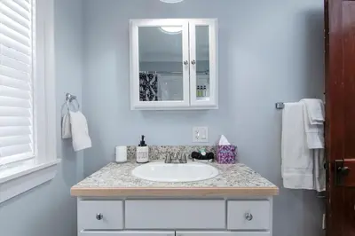 a bathroom with a sink and a mirror at Fully-stocked Kitchen, AC, WiFi, WD, Near Baseball and Downtown in Oneonta