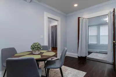 a dining room with a table and chairs at Fully-stocked Kitchen, AC, WiFi, WD, Near Baseball and Downtown in Oneonta
