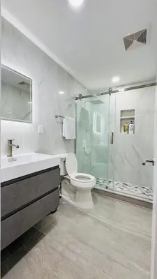 a bathroom with a shower and a toilet and a sink at Fancy private home