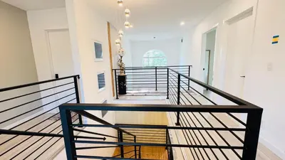 a staircase in a home with a black railing at Fancy private home