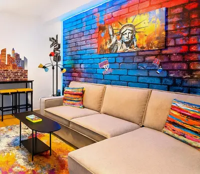 a living room with a couch and a brick wall at Hoboken Hideaway - Walk to Transit - 15 Mins to NYC in Hoboken