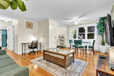a living room with a couch and a table at Crested One Place in Manchester