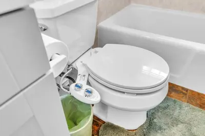 a bathroom with a white toilet and a bath tub at Crested One Place in Manchester