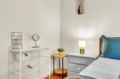 a bedroom with a bed and a dresser with a mirror at Crested One Place in Manchester