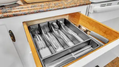 a kitchen sink with utensils in a drawer at Crested One Place in Manchester