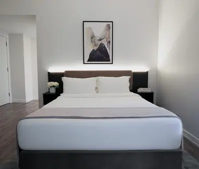 a bedroom with a large bed with white sheets at One Dutch Hotel in New York
