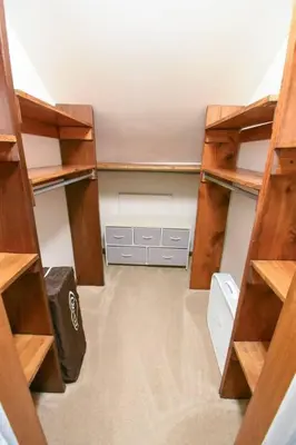 an empty room with wooden shelves in a room at Hudson Valley Haven - NY in Red Hook