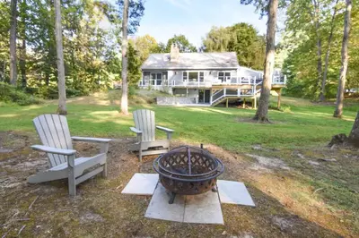 two chairs and a fire pit in front of a house at Hudson Valley Haven - NY in Red Hook