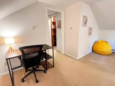 a room with a desk and a chair and a yellow ball at Hudson Valley Haven - NY in Red Hook