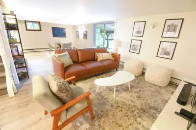 a living room with a couch and a table at Hudson Valley Haven - NY in Red Hook