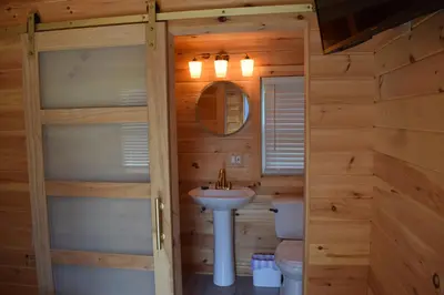 a bathroom with a sink and a toilet at Saratoga Cabins in Malta