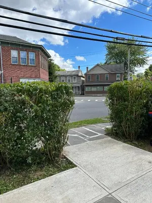 a street with two bushes in front of a building at Saugerties Waterfront Getaway in Saugerties