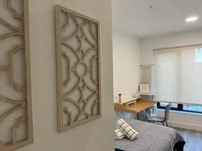 a bedroom with a wooden panel on the wall at Cozy apt with City skyline rooftop in Union City