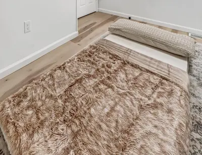 a rug sitting on the floor in a room at Hip Dtwn Apt With Arcade And Gym in Binghamton