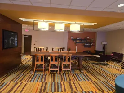 a conference room with a large wooden table and chairs at Fairfield by Marriott in Paramus