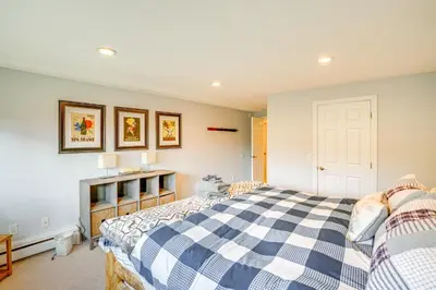 a bedroom with a blue and white checked bed at Mtn and Foliage Views Modern Mount Snow Stay! in Dover