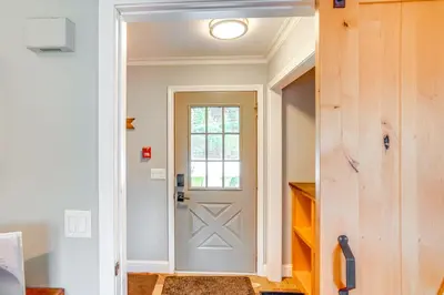 a hallway with a door and a window at Mtn and Foliage Views Modern Mount Snow Stay! in Dover