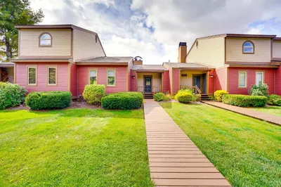 a large pink house with a grass yard at Mtn and Foliage Views Modern Mount Snow Stay! in Dover