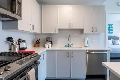 a kitchen with white cabinets and a stove top oven at Luxury Apt Near Downtown in Stamford