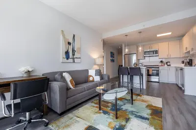a living room with a couch and a table at Luxury Apt Near Downtown in Stamford